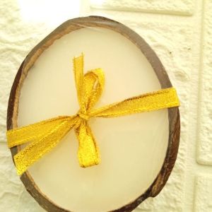 Aromatic Vanilla Essence Candle in Natural Coconut Shell. front view 